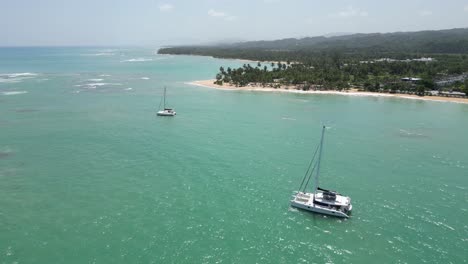 Luxurious-catamarans-in-the-turquoise-waters-at-Punta-Popy-beach-in-Las-Terrenas-on-the-caribbean-island-of-Dominican-Republic