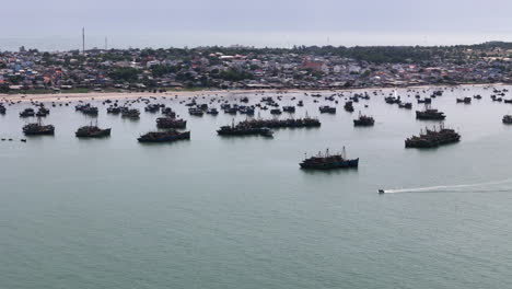 Silhouette-of-massive-fishing-vessels-near-Vietnam-coastline,-aerial-view