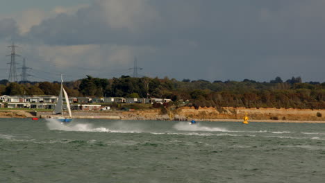 two-jet-skis-playing-around-on-the-Calshot-spit-by-the-Solent,-Southampton