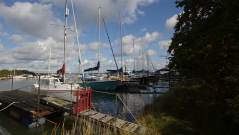 Planning-shot-of-sailboats-moored-up-at-high-tide-at-Ashlett-creek-sailing-club-in-the-Solent,-Southampton