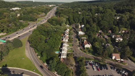 Cinematic-4K-Aerial-shot-of-American-neighborhood-highway-Blue-sky-summer