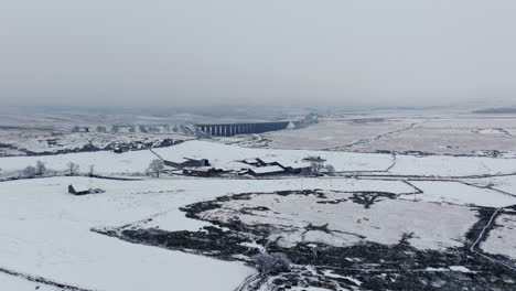 Establishing-Aerial-Drone-Shot-of-Snowy-Yorkshire-Dales-and-Ribblehead-Viaduct-in-Winter-UK