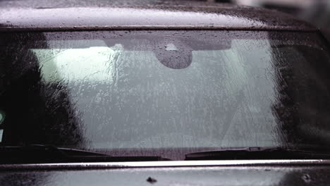 Super-slow-motion-footage-of-raindrops-hitting-the-the-windshield-of-a-car