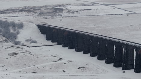 Absteigende-Drohnenaufnahme-Des-Ribblehead-Viadukts-An-Einem-Verschneiten-Tag-In-Yorkshire-Dales,-Großbritannien