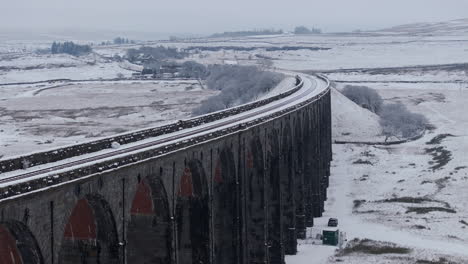 Pullback-Establishing-Aerial-Drone-Shot-of-Snowy-Ribblehead-Viaduct-with-Long-Lens-in-Yorkshire-Dales-UK