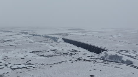 Erstellen-Einer-Luftdrohnenaufnahme-Des-Ribblehead-Viadukts-An-Einem-Verschneiten-Und-Düsteren-Tag-In-Den-Yorkshire-Dales-Im-Winter-In-Großbritannien