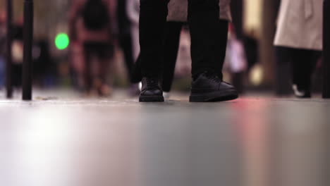 Slow-motion-footage-of-black-shoes-walking-on-the-sidewalk-in-Paris,-France