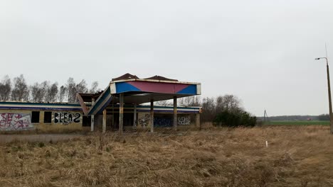 Abandoned-and-collapsed-gas-station-building-in-rural-yellow-grass-area