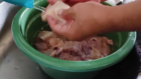 close-up-of-washing-chicken-meat-with-water