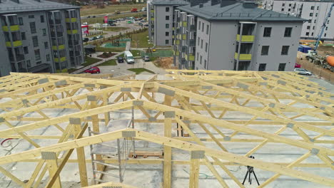 Wooden-Timber-Framework-Rooftop-Under-Construction-Close-Up-with-Low-Aerial-Drone-Shot-Angle