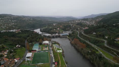 Aerial-establishing-view-of-Velle-water-dam-and-power-plant-in-city-of-Ourense,-Galicia,-Spain-on-grey-cloudy-day