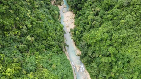 Creek-water-flowing-through-gorge-of-lush-green-jungle,-Cebu