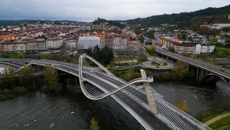 Millennium-Bridge-Miño-River-in-Ourense,-Galicia,-Spain,-aerial-parallax-around-unique-pathway