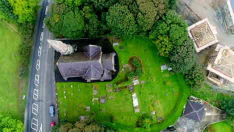 Overhead-spinning-drone-shot-of-the-Holy-Trinity-Church-of-Ireland-and-neighborhood-in-Londonderry,-Ireland
