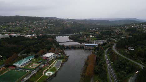 Drone-push-in-to-Velle-water-dam-and-power-plant-in-Ourense,-Galicia,-Spain