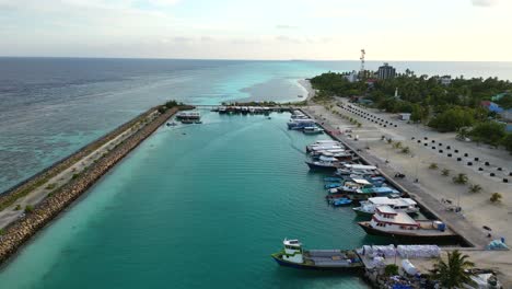 Aerial-view-over-Dhangethi-Bridge-Harbour-including-fishing-and-dive-boats,-Maldives,-Indian-Ocean