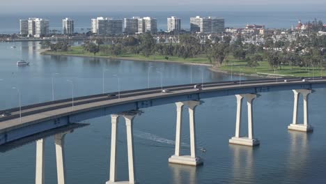 Coronado-Bay-suspension-bridge,-aerial-static-view-overlooking-scenic-cityscape-skyline-of-San-Diego