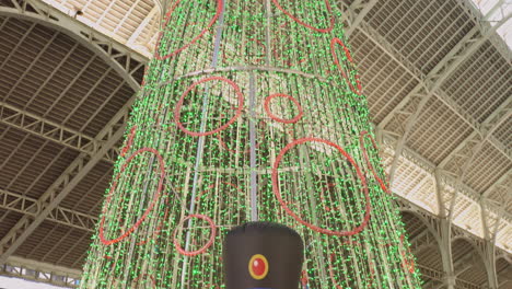 Tilt-shot-of-Christmas-decorations-at-Mercado-de-Colon-in-Valencia,-Spain