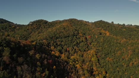 Autumn-Skyline,-Drone-Fly-Above-Green-Orange-and-Golden-Trees-in-Mountain-Range-European-Concept,-Establishing-Shot