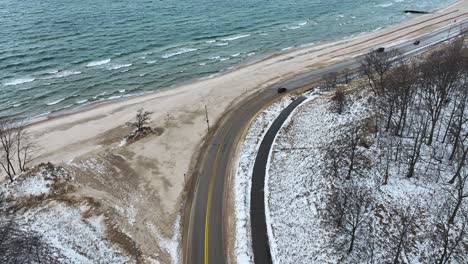 A-coastal-road-covered-in-sand-and-snow
