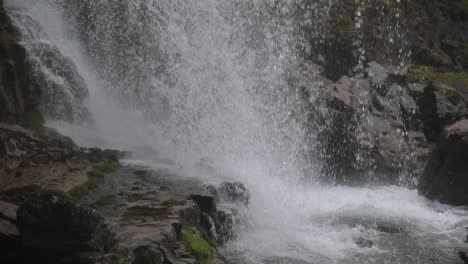 pan-on-water-drops-and-flow-at-Waterfall-of-Vallesinella-and-landscape,-Madonna-di-Campiglio,-Trentino-Alto-Adige,-Italy