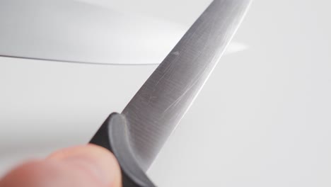 Man-sharpening-a-knife-with-another-knife