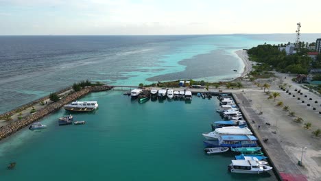 Aerial-view-of-Dhangethi-Bridge-Harbour-including-fishing-and-dive-boats,-Maldives,-Indian-Ocean