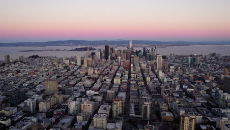 Aerial-view-away-from-downtown-San-Francisco,-vibrant-evening-in-California,-USA