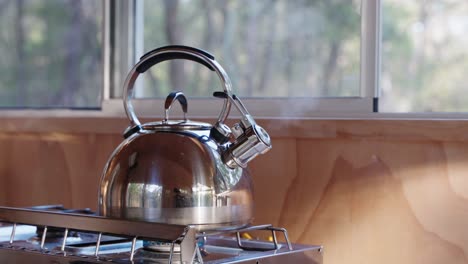 Whistle-kettle-boils-in-the-morning-light-of-tiny-cabin