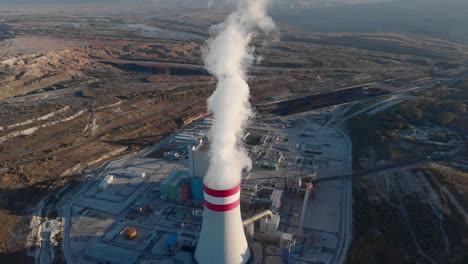 Drone-coal-fired-power-station-plant-cooling-towers-emitting-steam-tilt-up