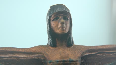 Dreamy-macro-shot-of-a-Cleopatra-statue-with-wide-open-wings,-hazy-depth-of-field,-ancient-Egypt-Queen-of-Kings,-Egyptian-historical-ruler,-antique-artwork-of-a-goddess,-smooth-4K-video-zoom-out