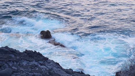 High-angle-closeup-of-cinematic-splash-crash-sea-undertow-waves-cliff,-Tenerife