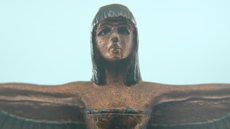 Dreamy-macro-shot-of-a-Cleopatra-statue-with-wide-open-wings,-hazy-depth-of-field,-ancient-Egypt-Queen-of-Kings,-Egyptian-historical-ruler,-antique-artwork-of-a-goddess,-4K-video-zoom-out-tilt-down