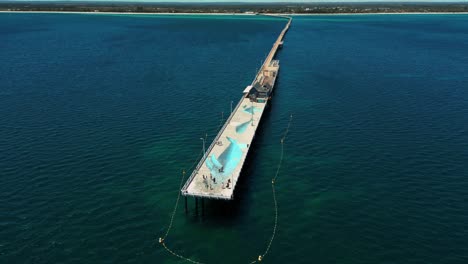 drone-shot-over-the-Busselton-Jetty-in-Western-Australia,-the-longuest-Jetty-in-the-Southern-Hemisphere-with-almost-2km