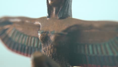 Dreamy-macro-shot-of-a-Cleopatra-statue-with-wide-open-wings,-hazy-depth-of-field,-ancient-Egypt-Queen-of-Kings,-Egyptian-historical-ruler,-antique-artwork-of-a-goddess,-4K-video-tilt-up
