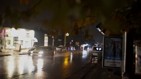 Rainy-night-footage-from-streets-of-Kifissia,-low-traffic-,-pull-focus-shallow-depth-of-field-4K