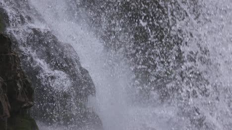 Closeup-of-drops-on-Waterfall-of-Vallesinella-and-landscape,-Madonna-di-Campiglio,-Trentino-Alto-Adige,-Italy