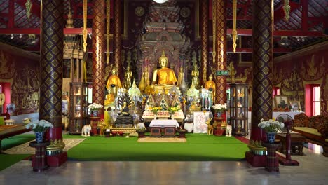 Camera-approach-to-big-golden-Buddha-inside-Wat-Chiang-Man-Temple-of-Thailand