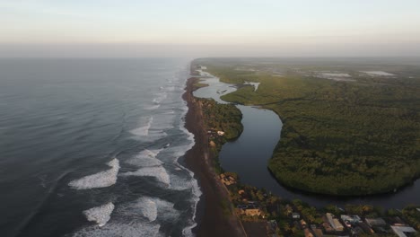 Wide-view-of-El-paredon-surfing-village-at-Guatemala-during-sunrise,-aerial