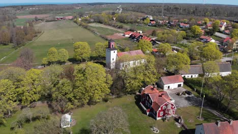 Aerial-view-of-beautiful-quaint-countryside-in-Sweden,establishing-shot