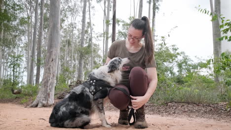 Best-friend-of-the-human,-woman-playing-with-her-Australian-Shepherd-dog-outdoors