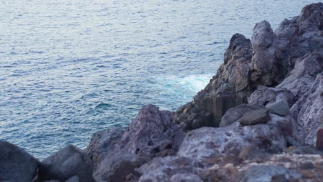 Rocky-volcanic-coast-in-Los-Gigantes-Tenerife,-rocks-and-wavy-sea,-sunset
