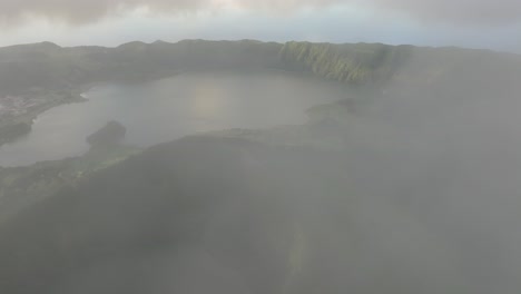 Flying-through-clouds-and-reveal-Lagoa-de-Santiago-and-lagoa-Azul-in-Azores,-aerial