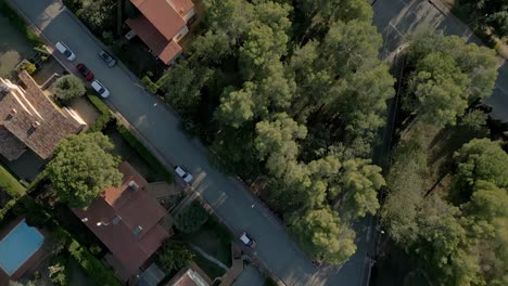 Aerial-Establishing-Shot-above-European-Countryside-Neighborhood-Gardens-Pools-for-Swimming-and-Cars-Driving-By