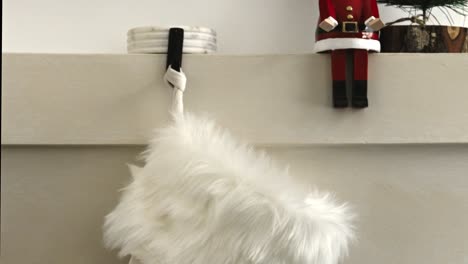 christmas-gift-sliding-in-a-santa-sock,-santa-claus-bringing-gifts-in-Christmas-stockings