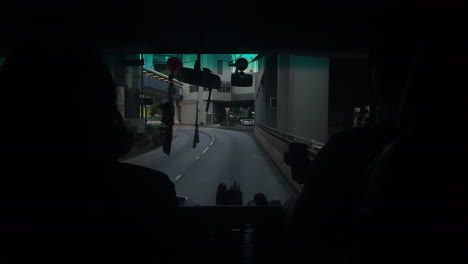 View-from-passenger-inside-of-a-car-driving-on-the-road-in-Hong-Kong-city,-China