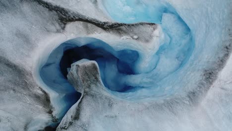 Aerial-view-of-water-flowing-inside-an-ice-cave