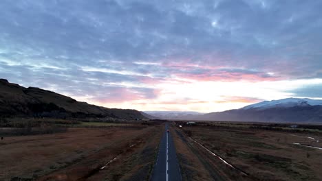 Vehicle-Driving-Towards-Highlands-During-Golden-Hour-In-South-Iceland---Drone-Shot
