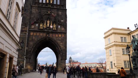 Entrance-to-the-Charles-Bridge-through-the-arch-of-the-Old-Town-Bridge-Tower,-Prague,-Czech-Republic