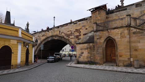 Traffic-under-the-Charles-Bridge-in-Prague,-Czech-Republic